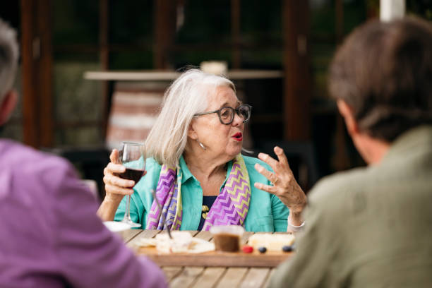 istock Active senior woman enjoying wine tasting event 2205510285