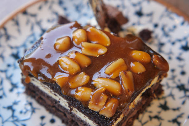 Indulgent and Delicious Chocolate Layer Cake generously topped with Peanut Delights