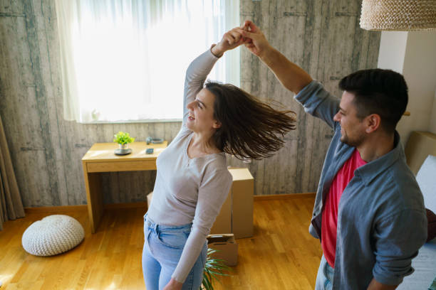 istock Happy couple spinning in their new apartment 2205514966