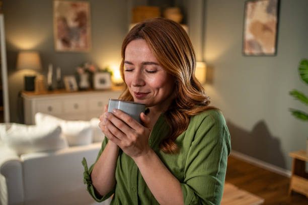 istock Serene woman enjoying a warm aromatic beverage at home 2205515998