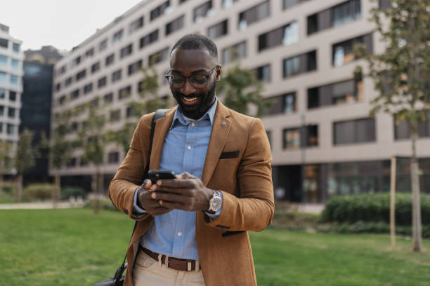 istock Businessman Using Smartphone Outdoors in City 2205516058