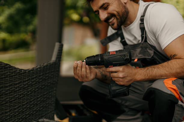 istock Handyman changing drill bit while assembling furniture outdoors 2205516748