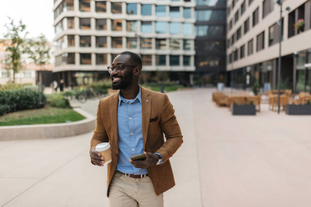 istock Smiling man enjoying coffee in a modern urban area 2205517056