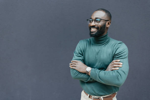 Smiling man with arms crossed and glasses on face