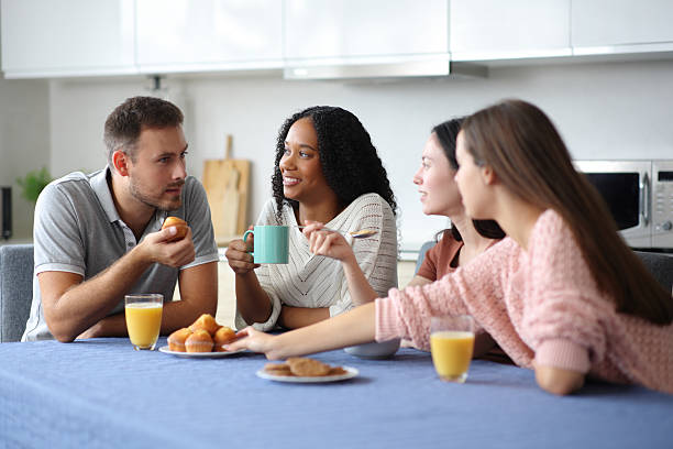 istock Interracial group of friends talking in a kitchen 2205518579