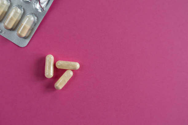istock Blister pack with capsules on pink background 2205519817