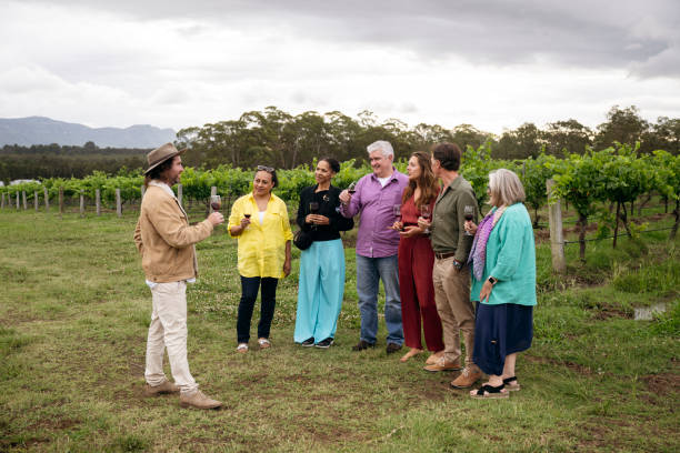 istock Mixed-age group of wine lovers outdoors on tour of vineyard 2205520621
