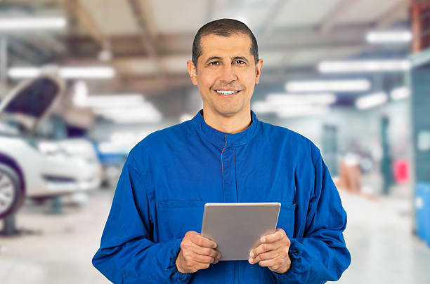 istock Smiling professional handyman in blue overalls 2205522079