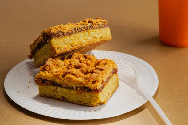istock Homemade jam and crumb cake on a sandy background on disposable tableware. Quick preparation of homemade food and a calorie-rich dessert for a picnic. 2205522391