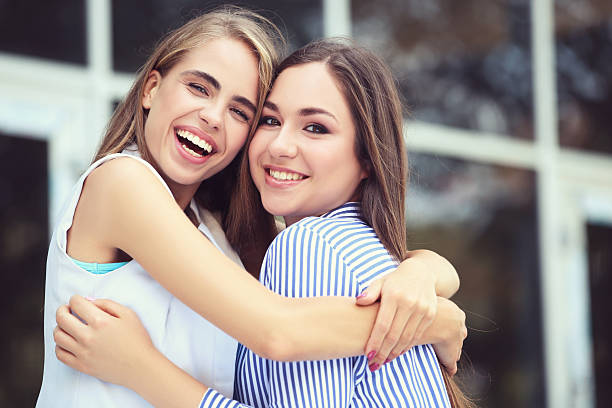 istock Two young happy girlfriends on the street 2205525483