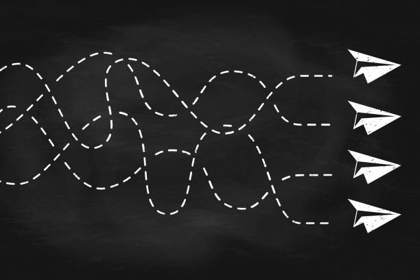 istock Group of paper plane flying different directions on black chalkboard 2205526442