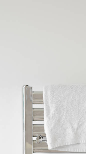 istock Fresh white towel on a modern heater, elegant home decor, soft and cozy. 2205526658
