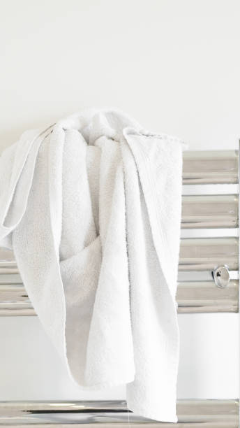 istock Fresh white towel on a modern heater, elegant home decor, soft and cozy. 2205526712