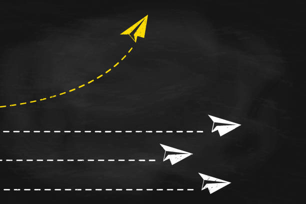 istock Yellow paper plane changing direction on black chalkboard. New idea, change concept of business 2205527269