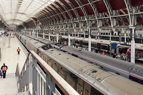 London, UK - September 28 2024: Commuters hustle through London Paddington Station as trains arrive and depart during morning rush hour.