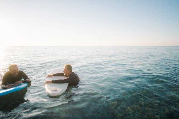 istock Father and son surfing together 2205530571
