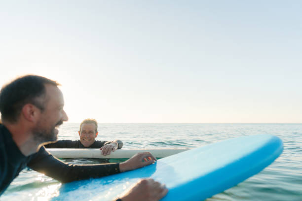 istock Father and son surfing together 2205530574