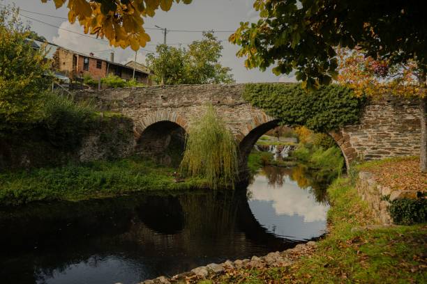 istock Old stone bridge over river with autumn foliage. 2205531240