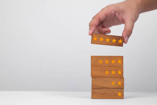 A hand placing a star-marked block on a stack, symbolizing achievement and progress. Ideal for business or education themes.