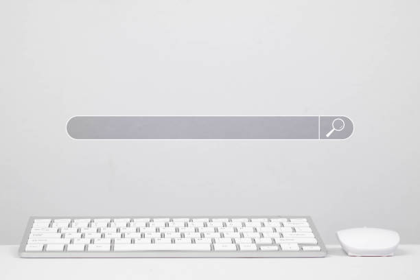 A minimalist workspace featuring a white keyboard and mouse with a search bar overlay, ideal for digital innovation themes.