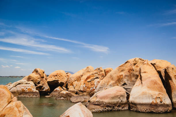 Sea coastline full of large rocks.