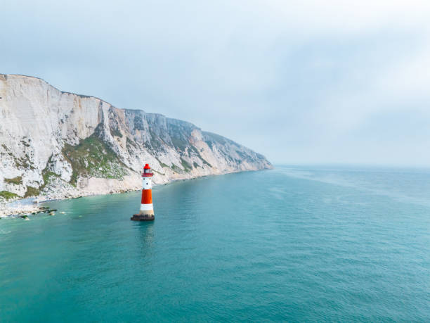 Lighthouse below the coastal cliffs called Seven Sisters in UK
