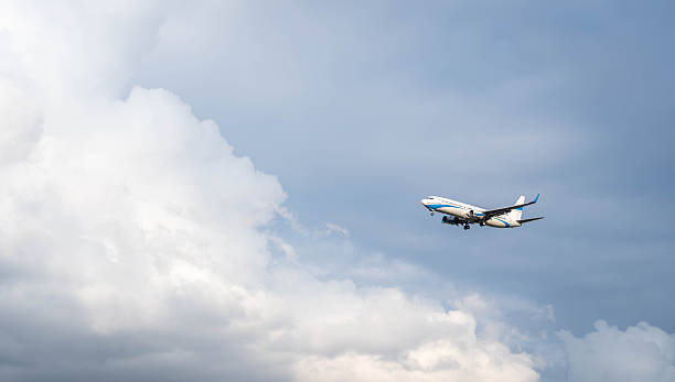 istock A passenger plane prepares for landing by opening its landing gear 2205539447