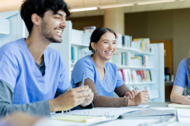 istock Two Smiling Medical Students Studying Together in Library 2205543828