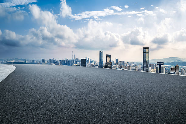 istock Empty asphalt road and cityscape with skyline in modern city 2205543875