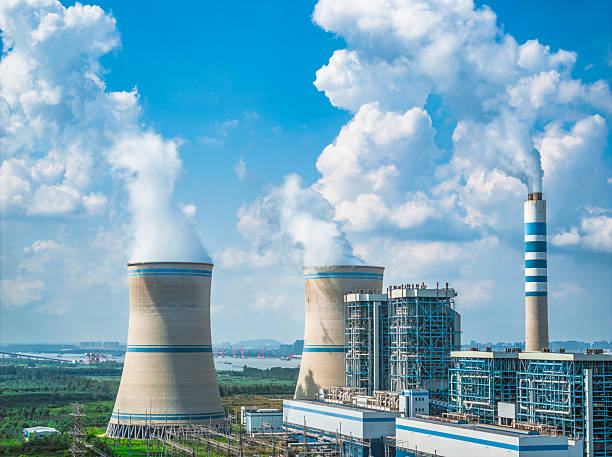 istock Coal power station with smoke emission and blue sky cloud background 2205543943