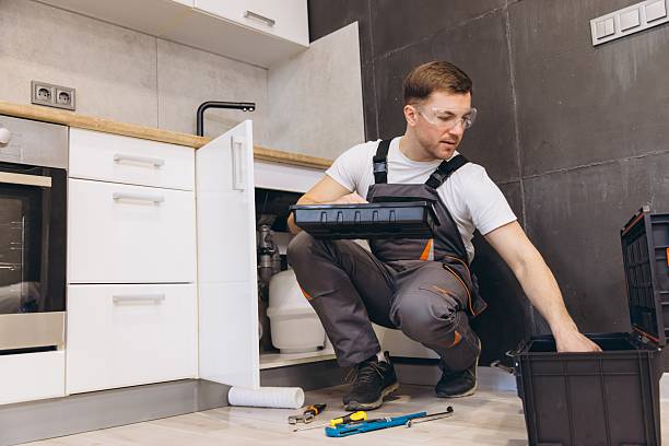 istock Plumber Installing or Repairing Water Filter System in Kitchen Sink 2205544524
