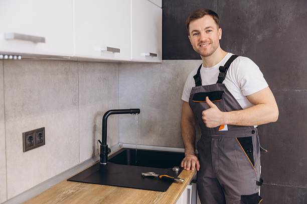 istock Plumber giving thumbs up after fixing kitchen faucet 2205544598