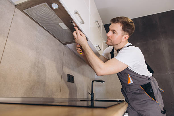 istock Professional plumber repairing kitchen extractor hood using screwdriver 2205544619