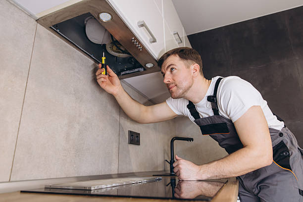 istock Plumber Repairing Extractor Hood in Modern Kitchen 2205544680