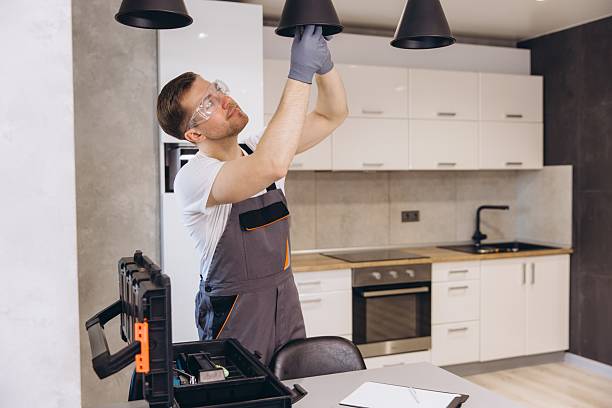 istock Electrician Installing Hanging Lamps in Modern Kitchen 2205544713