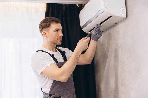 istock Plumber Repairing Air Conditioner Using Screwdriver 2205544787