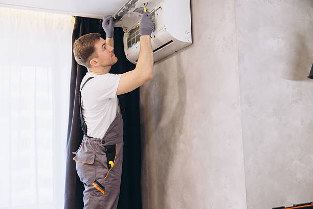 istock Technician Repairing Air Conditioner Unit on Wall 2205544816