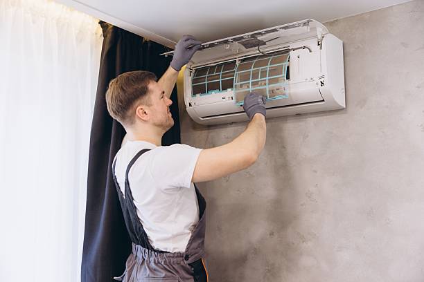 istock Technician Cleaning Air Conditioner Filter During Maintenance Service 2205544839