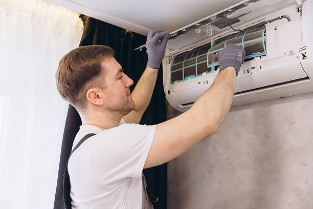 istock Professional electrician installing modern air conditioner unit 2205544864