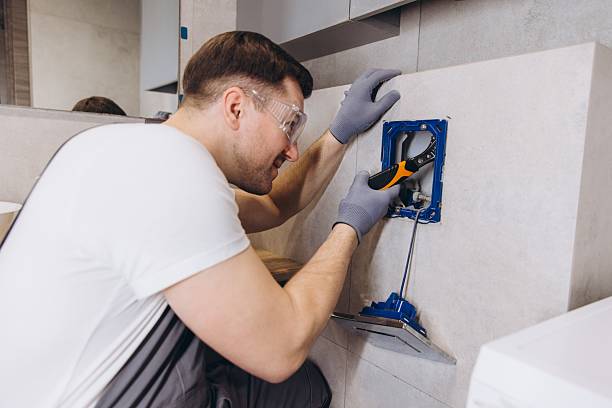 istock Plumber Installing Shower Faucet in Modern Bathroom 2205544900