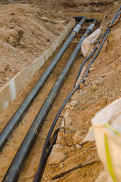 istock Pipes and Cables Laid in Trench, Construction Site, Underground Utilities, 2205545240