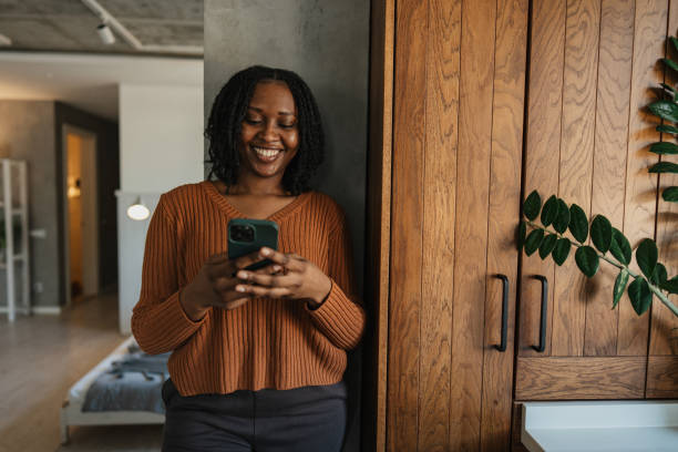 istock Happy woman using smartphone in stylish interior space 2205551229