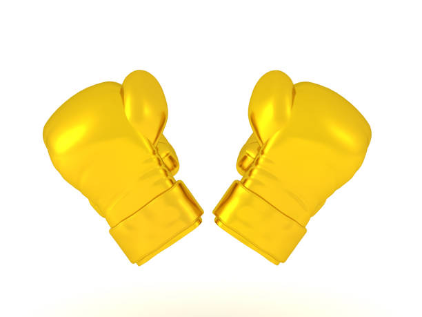 3D Rendering of two golden boxing gloves at an angle. 3D Rendering isolated on white.