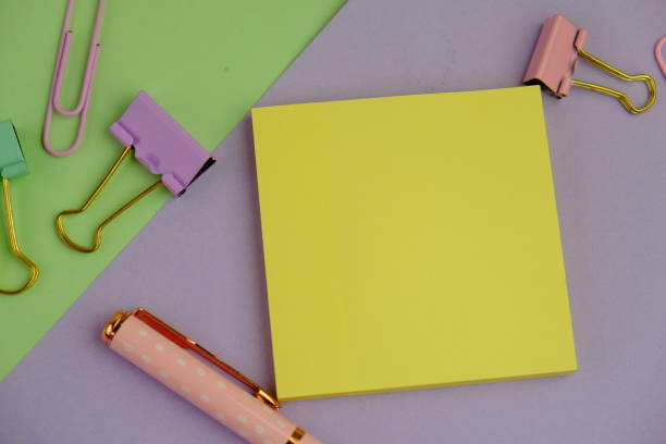 istock flat lay of a blank note book for text space. Educational and financial concept with text space on white background. surrounded by office tools. 2205556348