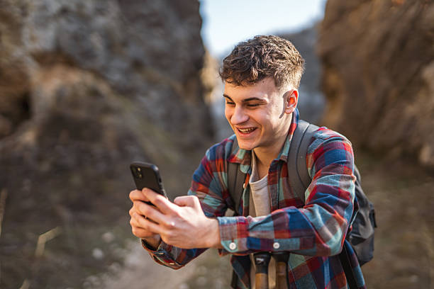 istock Young man hiker use mobile phone while take break from hiking 2205557127