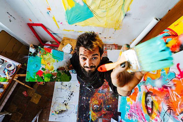 istock Artist Holding a Paintbrush and Palette from a Overhead Perspective 2205557683