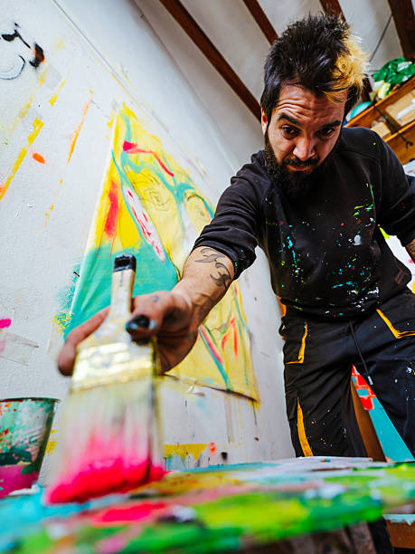 istock Expressive Artist Painting with Bold Colors and Dynamic Motion 2205558070