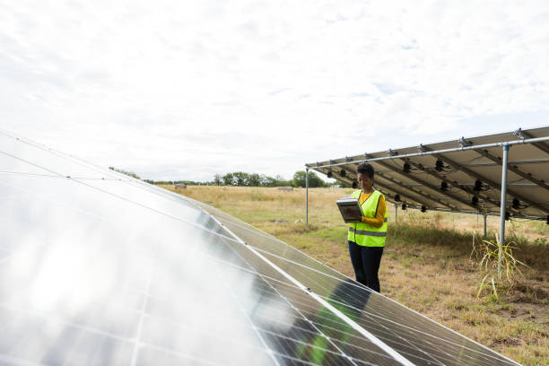 istock Woman inspecting solar panels at a Texas solar farm 2205558731