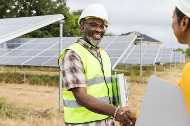 istock African American Solar Panel Engineer Handshake Outdoors 2205558782