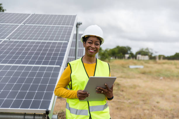 istock Confident Female Engineer Inspecting Solar Panels 2205558797